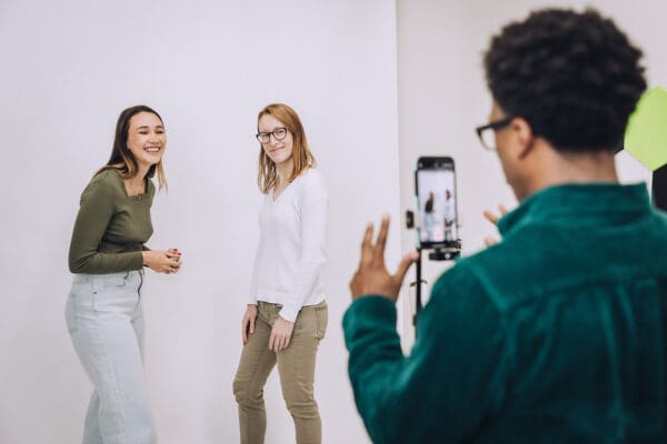 Daniel films Lauren and Meara on an iPhone.