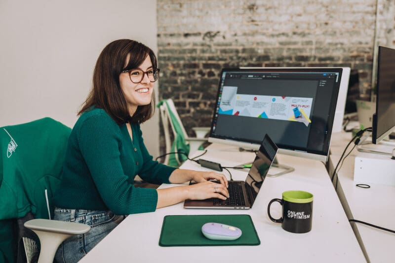 Claire smiles while working on a design file.