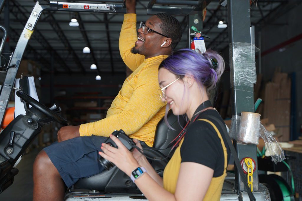 Optimists taking photos in a warehouse