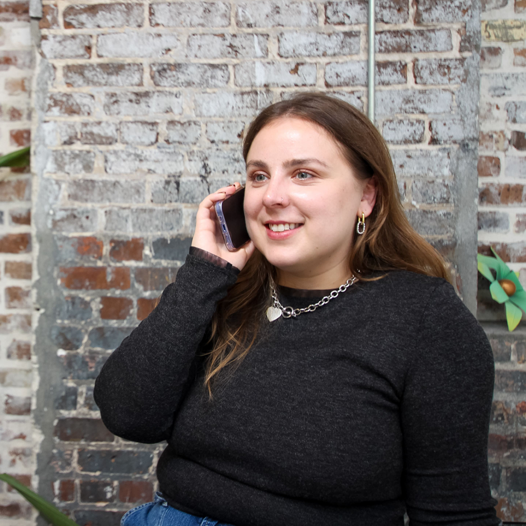 Natasha speaks on the phone in the office