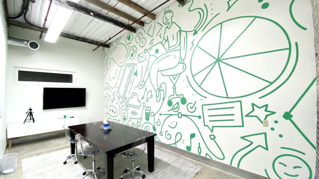 Interior of our New Orleans conference room. The wall features a mural designed by our team.