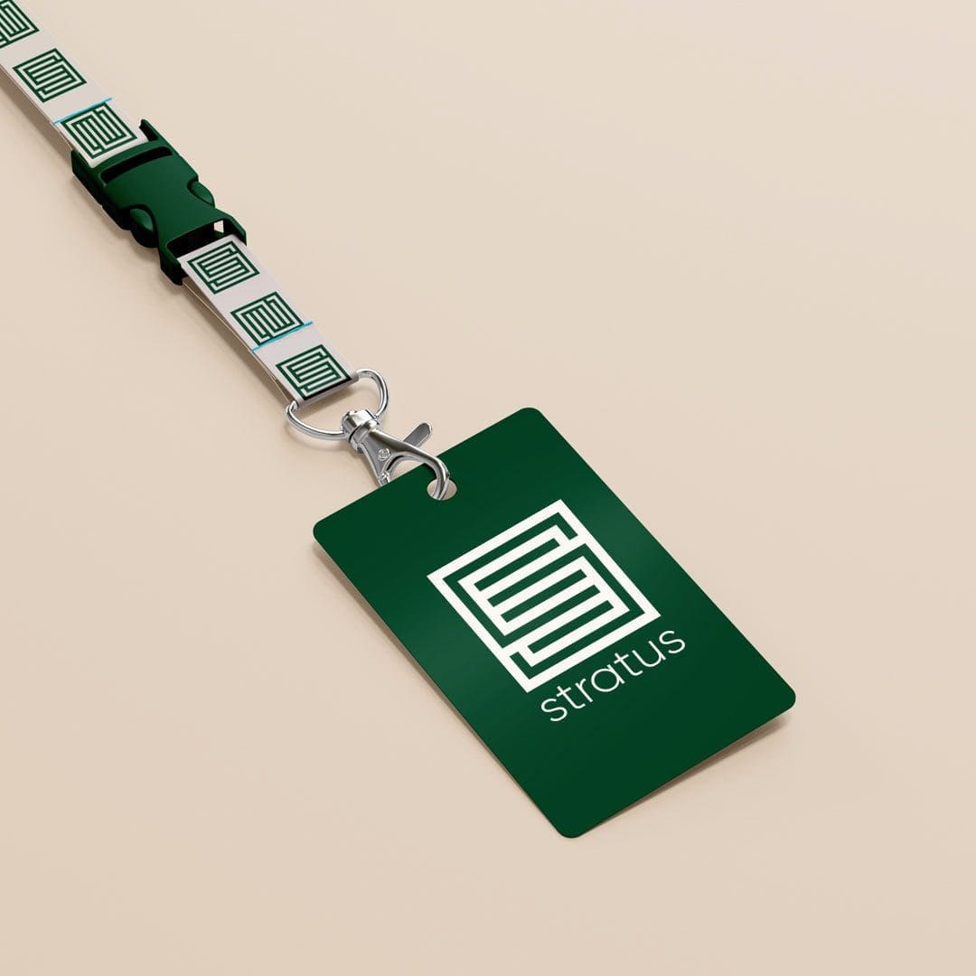 A lanyard and nametag with the Stratus "S" logo pattern.