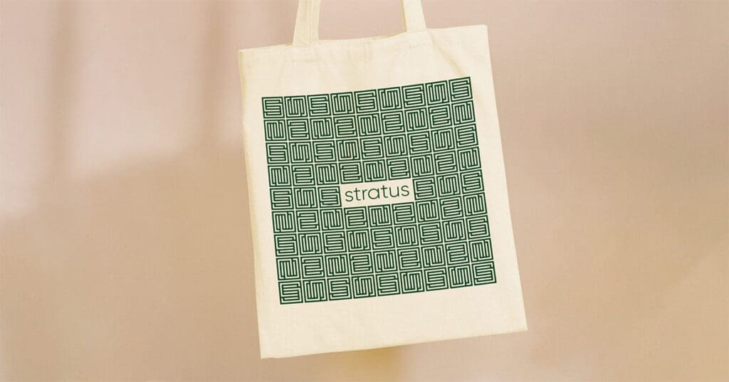 A tote bag with the Stratus logo and the interlocking "S" pattern.