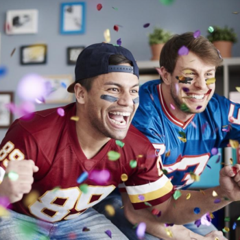 Three football fans celebrating while watching the game, an ideal audience for Super Bowl email marketing tactics