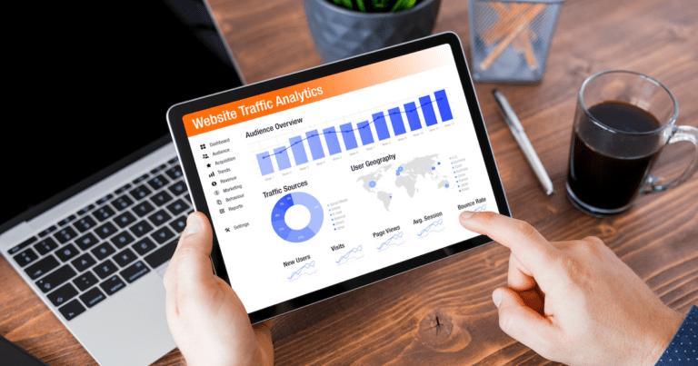 A person holding a tablet with website traffic analytics data displayed on it