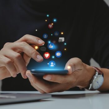 A staff member using LinkedIn from their phone with Sprout Social's Employee Advocacy