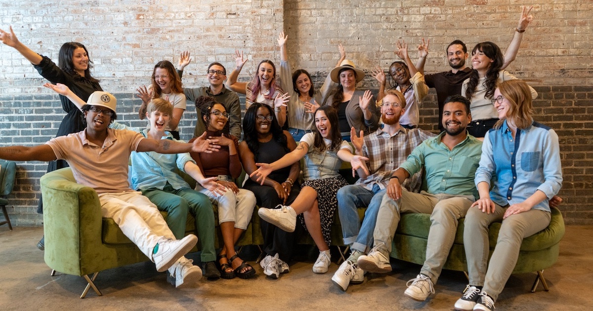 Group photo in the office from Online Optimism's Optimistic team retreat 2024!