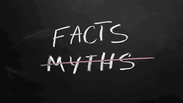 The word "Facts" written on a chalkboard, with the word "Myths" crossed out beneath it.