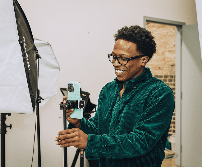 Daniel sets up an iPhone to film in the Online Optimism studio.