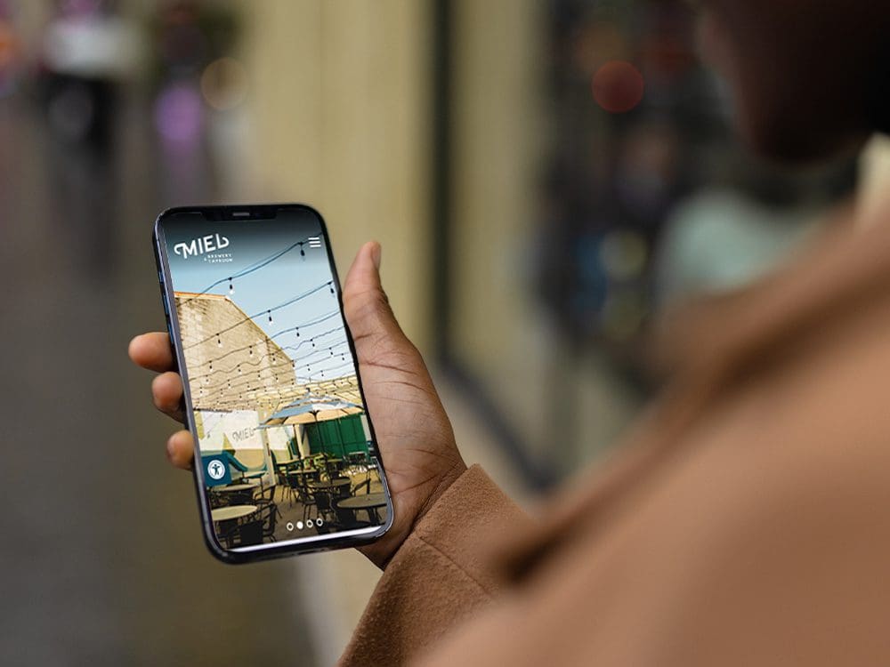 Person uses Miel Brewery's new website on a phone