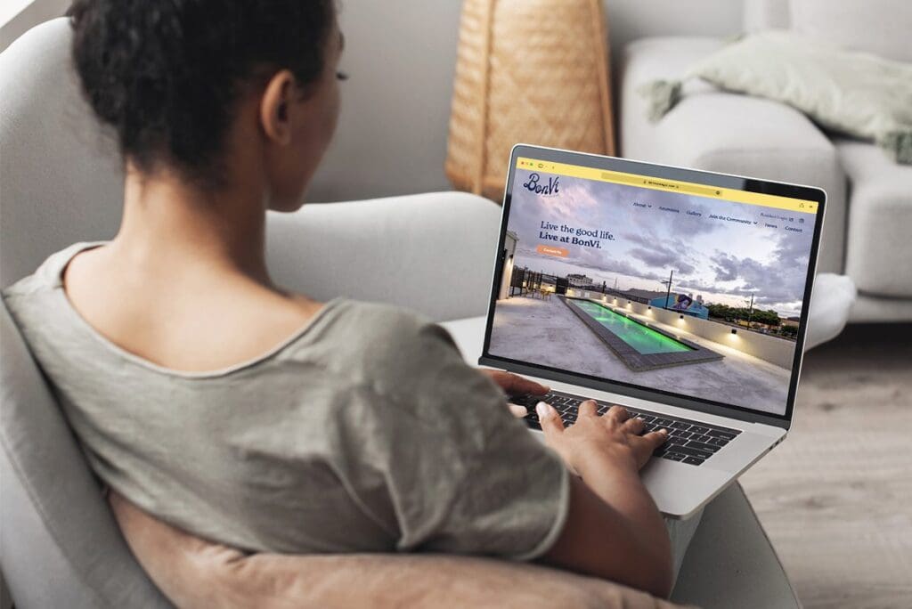 Woman uses BonVi's website on a laptop in her living room
