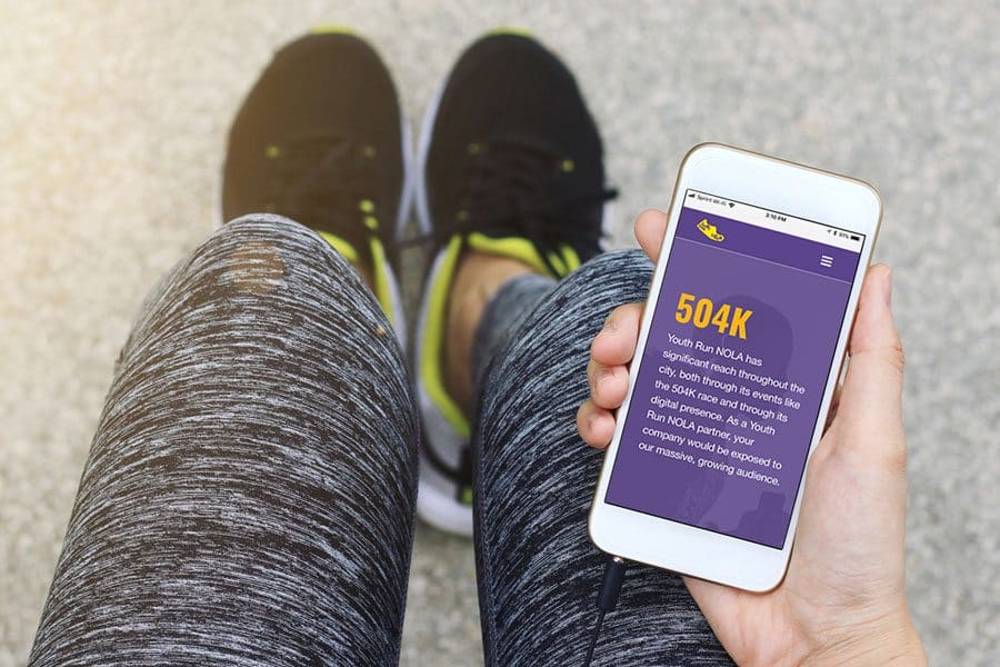 Runner uses Youth Run NOLA's new website on a phone