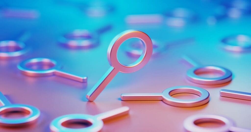 Metallic magnifier symbols illuminated by blue and pink lights on blue and pink background.
