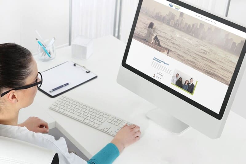 Woman uses MidCity TMS's new website on a desktop computer