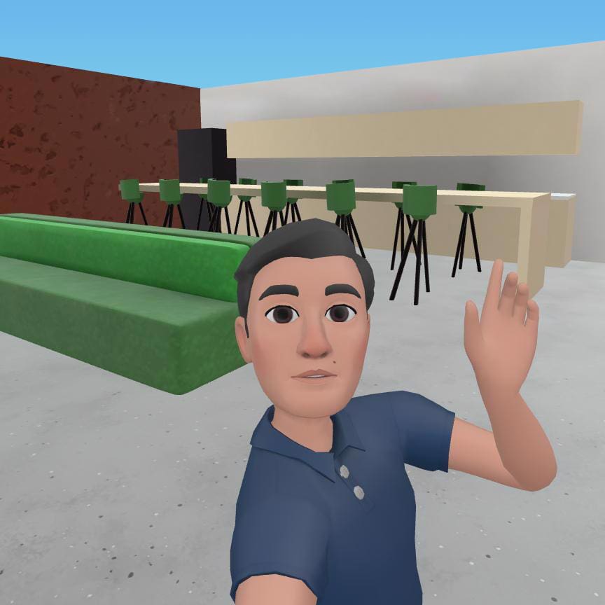 A Meta avatar waves at the camera in a Metaverse re-creation of the Online Optimism office.