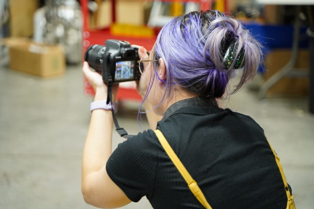 Meara takes a photo during a client photoshoot