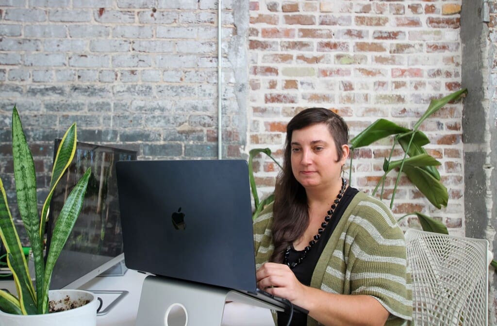 Amanda works on a laptop