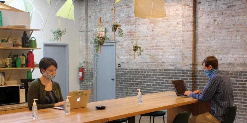 Sara Bandurian Working in a Mask at Online Optimisms Kitchen Table