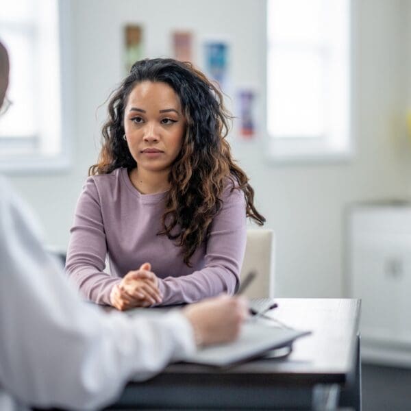 A person talks to their doctor in the doctor's office.