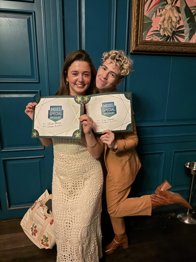 Online Optimism's Fall 2024 Specialist team, holding their OOie awards for "Most Special Specialist".