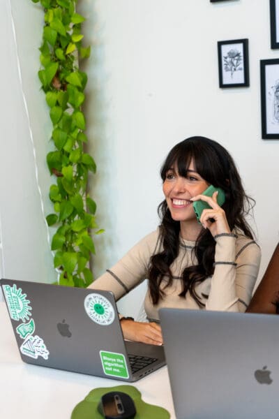 Jordan smiles as she speaks to a client on the phone