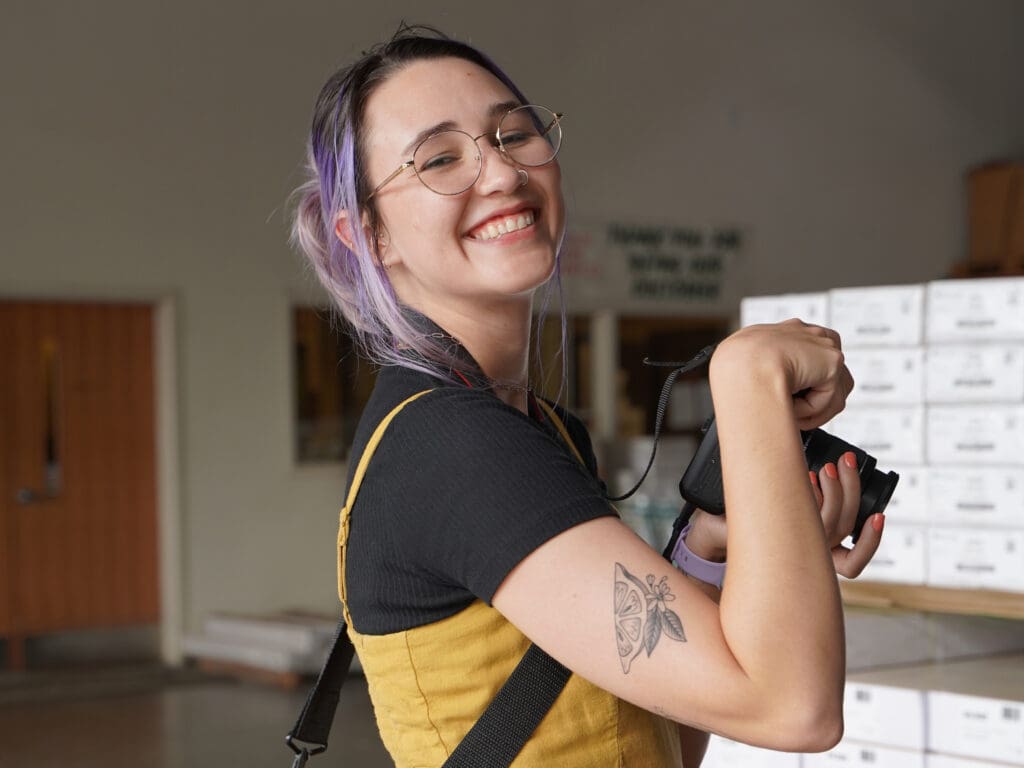 Meara smiles before taking a photo at a client's photoshoot