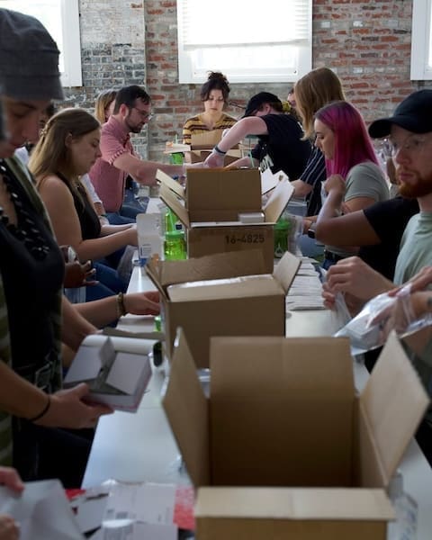Online Optimism staff assembling harm reduction kits for Trystereo as part of the 2025 company retreat
