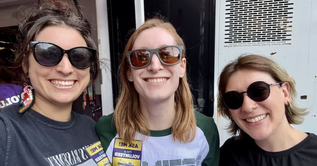 Sara, Lauren, and Erin volunteering in 2025