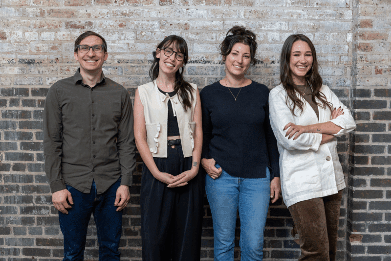 From left to right, Flynn, Jordan, Sara, and Meara pose for the camera at the office.