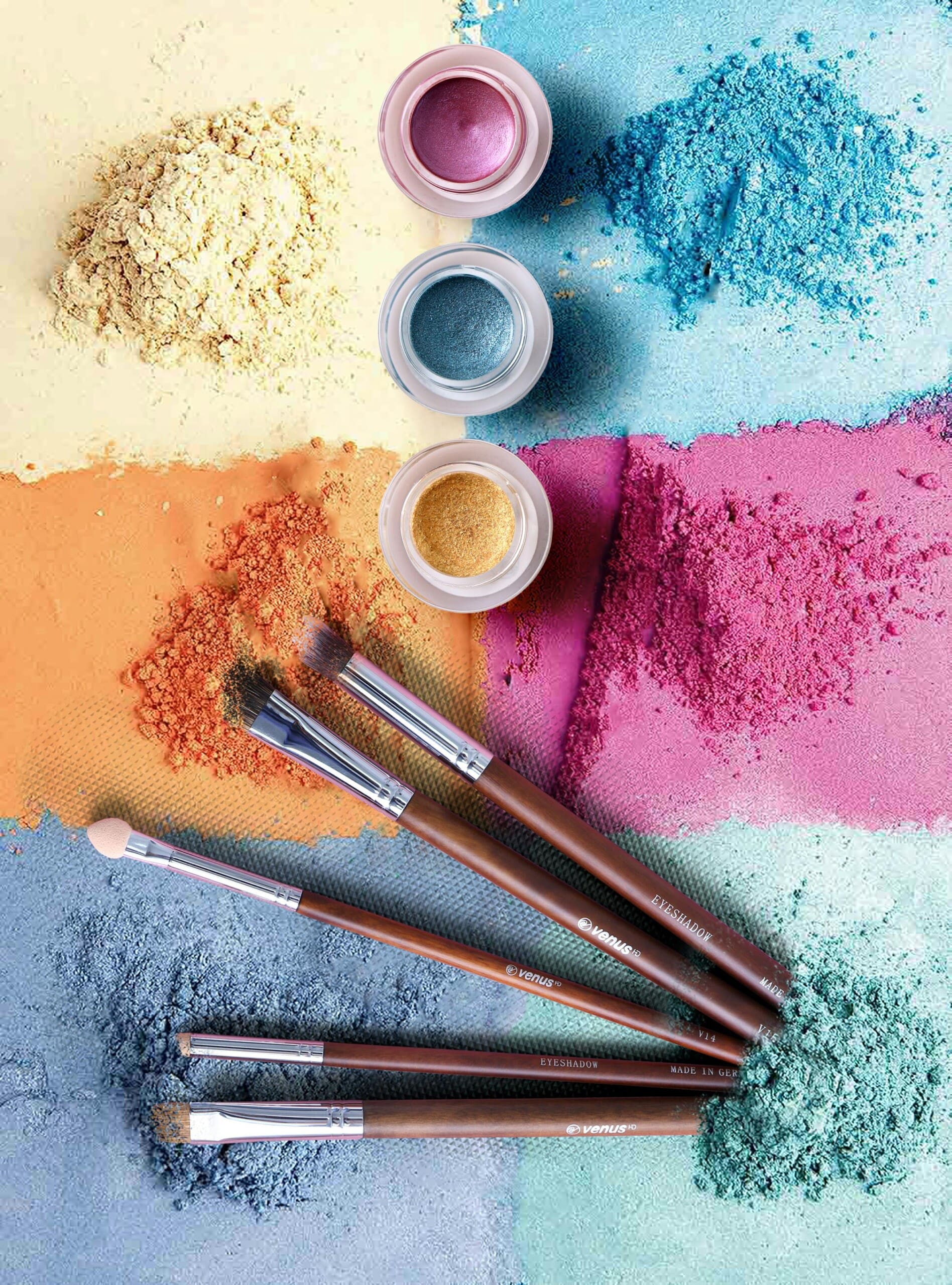 Makeup brushes and pots displayed against a background of colorful powders.