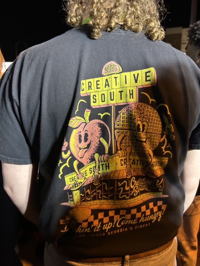 Person at bridge party with Creative South conference T-Shirt with a Waffle House theme.