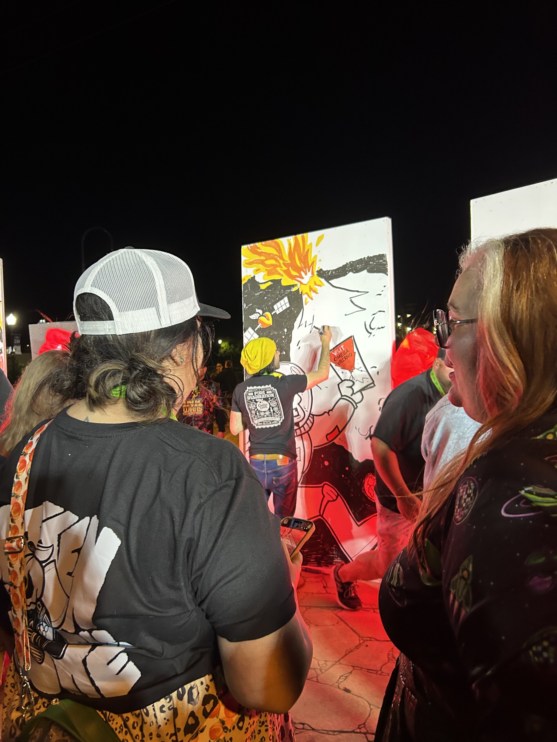 A crowd watches Alejo Porras work on a drawing during Creative South Ink Wars challenge