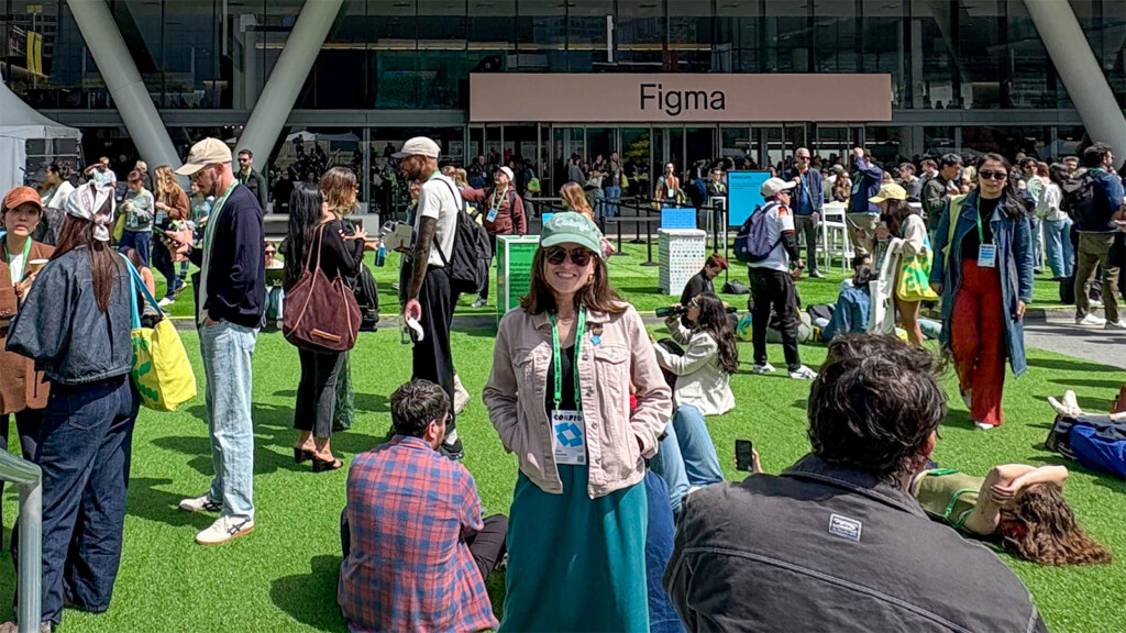Claire stands smiling among many people outside Figma's Config conference.