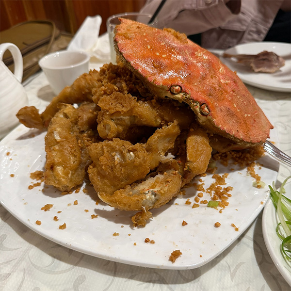 A fried, breaded Dungeness crab on a plate