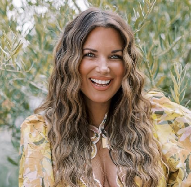 New Orleans influencer Dashin Darlin (Angelle Marix) smiles for the camera outdoors in a lively yellow dress.