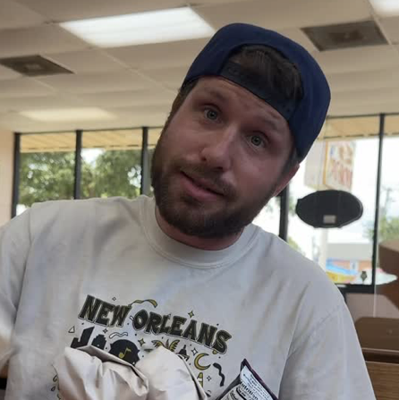 New Orleans influencer Hold The Mayo (Devin Snow) talks to the camera inside a restaurant.